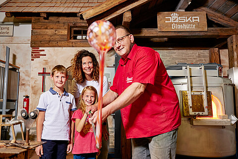 Familie beim Glasblasen in der JOSKA Glashütte – ein Erlebnis für Groß und Klein.